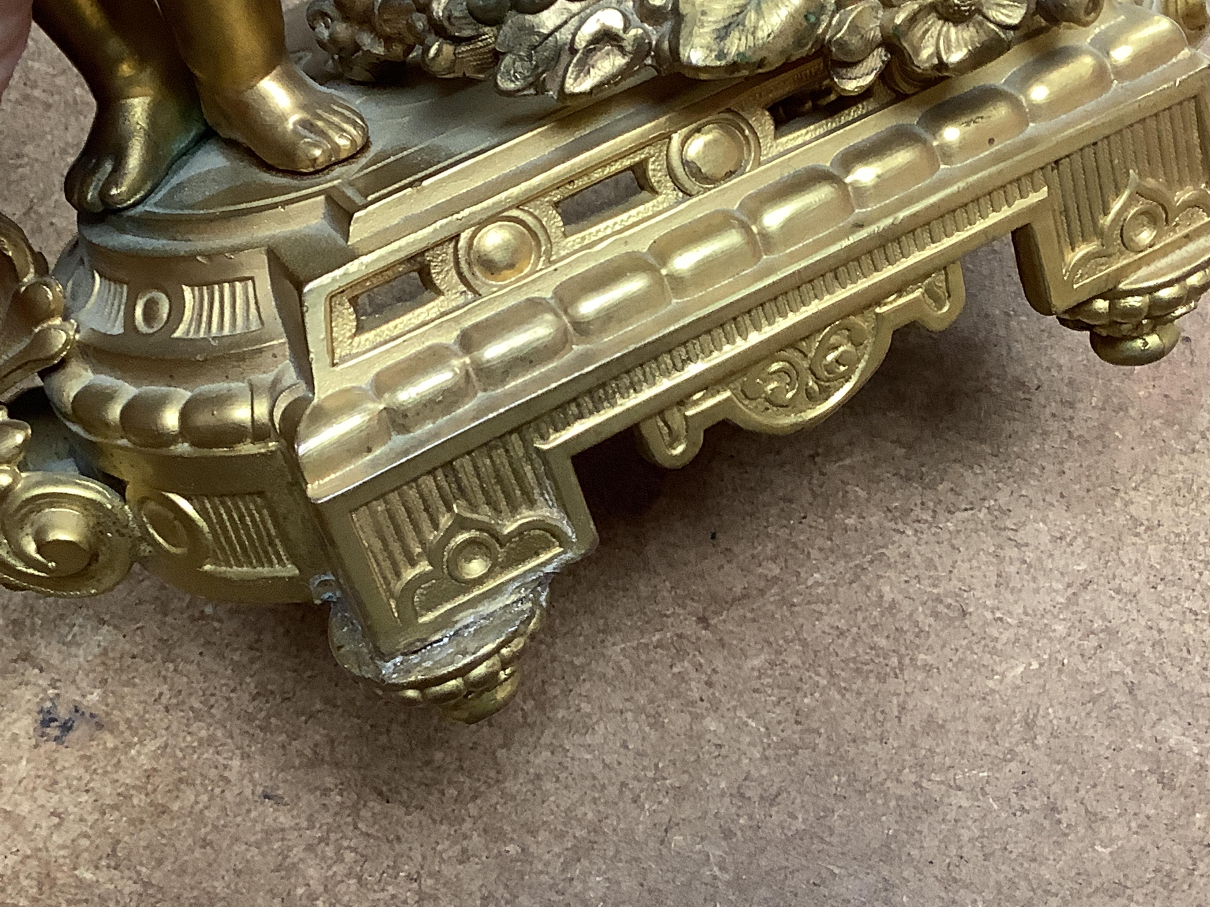 A late 19th century gilt metal cherub timepiece, Ansonia clock company movement, 21cm high
